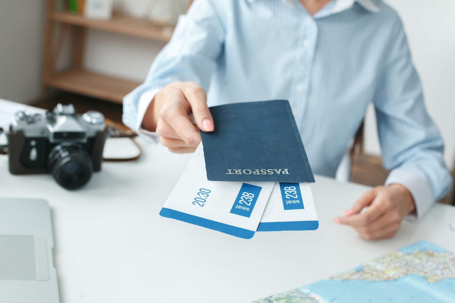 Young female travel agent consultant in tour agency documents close-up